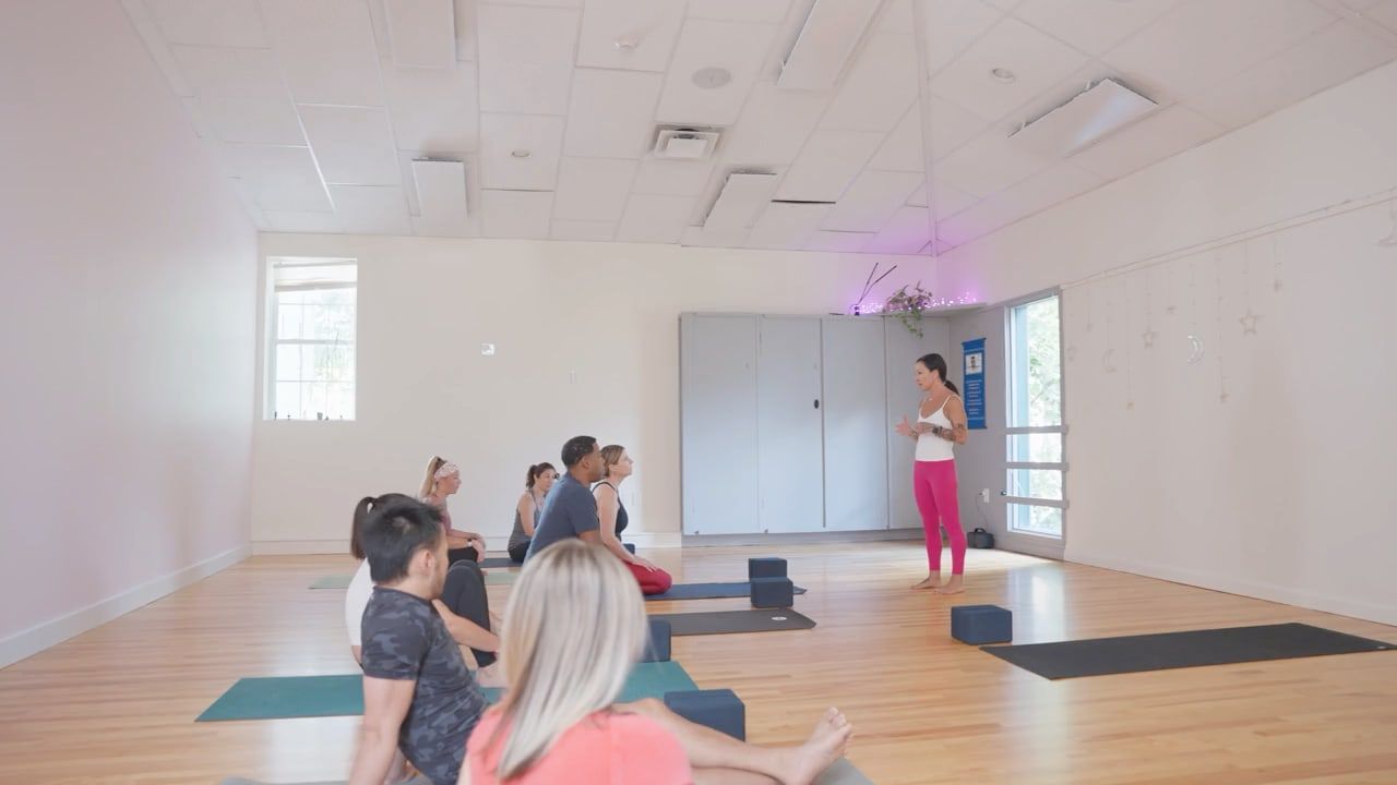 Karina leading a small group class on mats in the bright studio. Video: Welcome to OWL Fitness Studio.